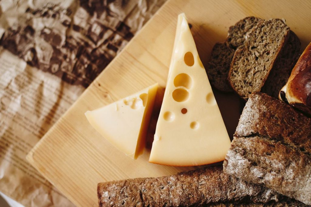 Image of probiotic cheese on a cutting board along with some bread