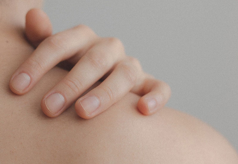 Image of someone's hand on their shoulder from behind