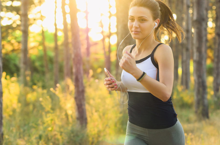 Image of a woman jogging in a forest