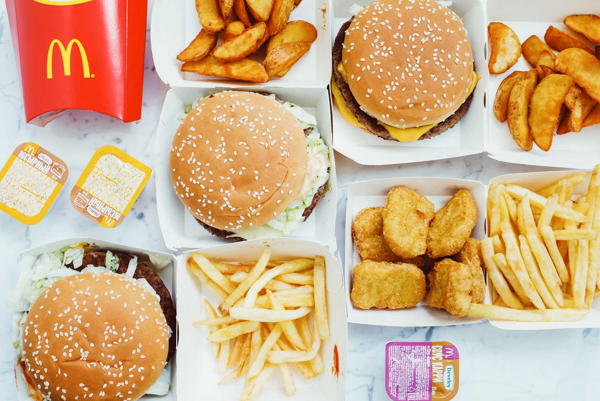 Image of unhealthy junk food on a table that are bad for nutrition